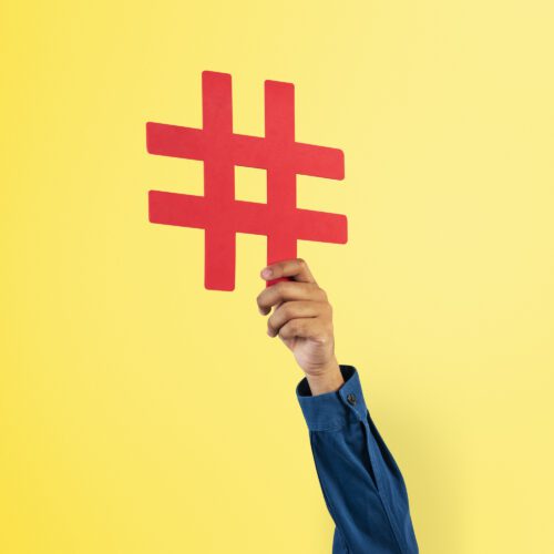 Hand holding hashtag marketing trending concept